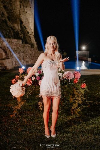 Cake cutting ceremony at Castello di Rocca Cilento with panoramic night view.