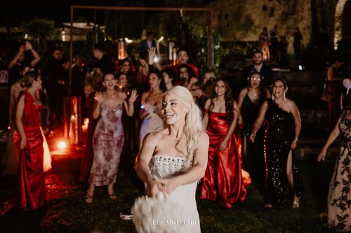 Cake cutting ceremony at Castello di Rocca Cilento with panoramic night view.