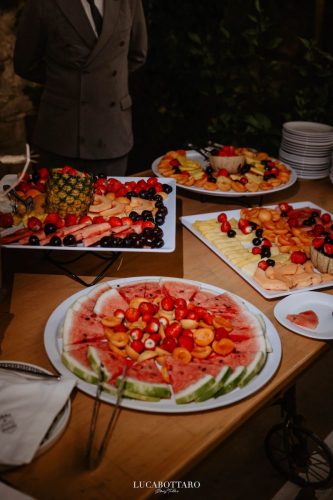 Cake cutting ceremony at Castello di Rocca Cilento with panoramic night view.
