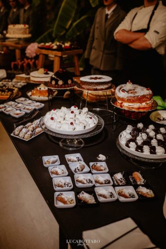 Cake cutting ceremony at Castello di Rocca Cilento with panoramic night view.