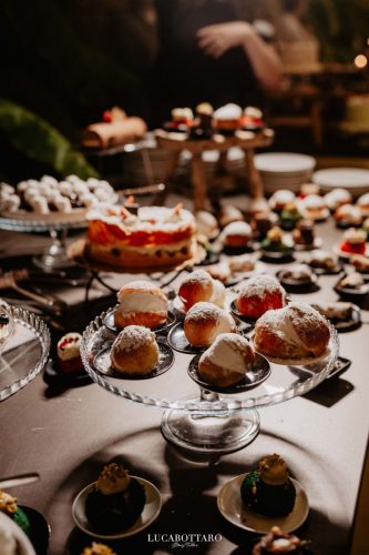 Cake cutting ceremony at Castello di Rocca Cilento with panoramic night view.