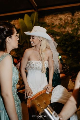 Cake cutting ceremony at Castello di Rocca Cilento with panoramic night view.