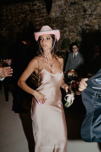 Cake cutting ceremony at Castello di Rocca Cilento with panoramic night view.