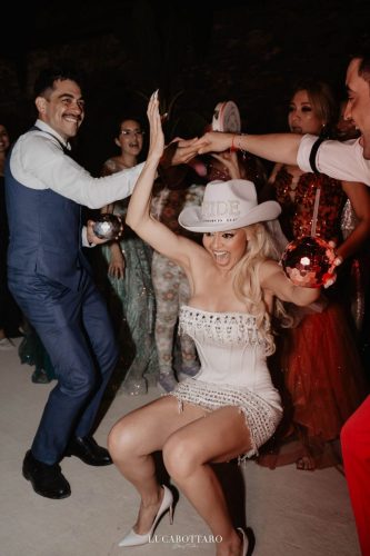 Cake cutting ceremony at Castello di Rocca Cilento with panoramic night view.