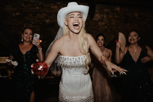Cake cutting ceremony at Castello di Rocca Cilento with panoramic night view.